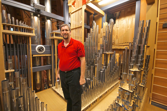 Matthew INSIDE the organ.  The keyboard and hall are behind the clock.