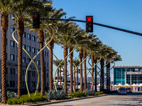 New palm trees and light poles between the station and the wharf.